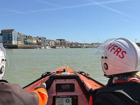 Crew at the helm of a rescue boat on a river