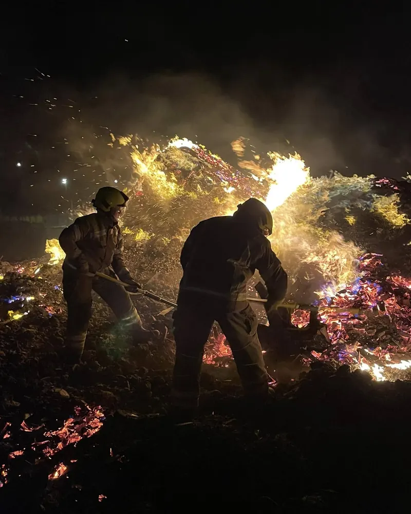 Two Sussex Volunteer Fire and Rescue firefighters working at a fire at night