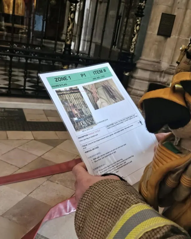 A firefighter holding a salvage plan with zone and item numbers